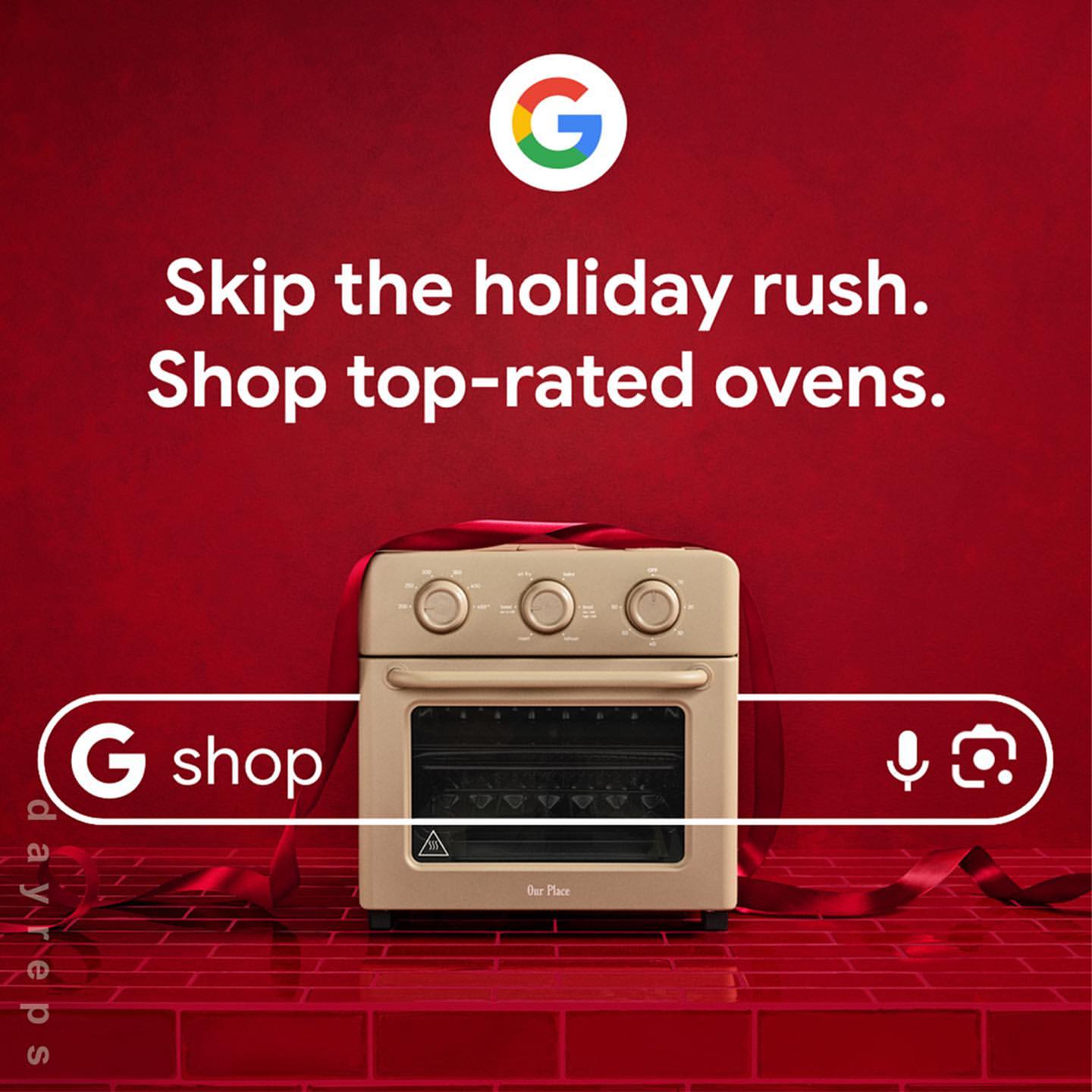 Beige-colored countertop oven displayed on a red brick surface, wrapped with a red ribbon, Google and ‘G Shop’ logos are visible.