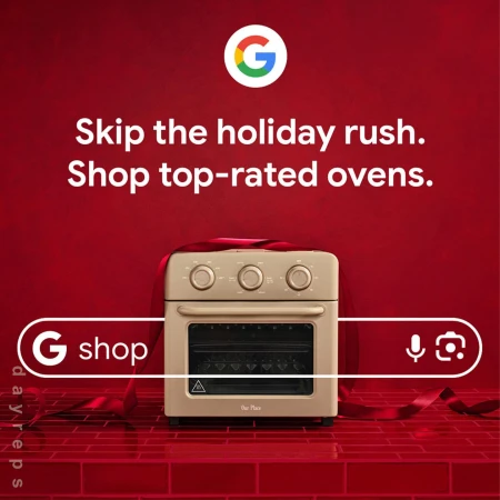 Beige-colored countertop oven displayed on a red brick surface, wrapped with a red ribbon, Google and ‘G Shop’ logos are visible.