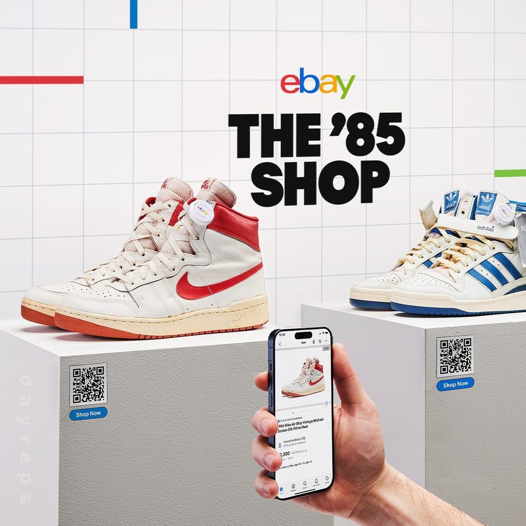 Ebay's '85 Shop showcases vintage high-top sneakers displayed on white pedestals, along with a mobile phone and a QR code.