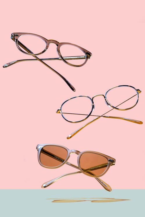 Three pairs of stylish eyeglasses are arranged on a split pastel background in an eye-catching floating product shot.