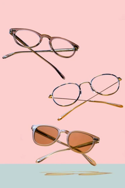 Three pairs of stylish eyeglasses are arranged on a split pastel background in an eye-catching floating product shot.