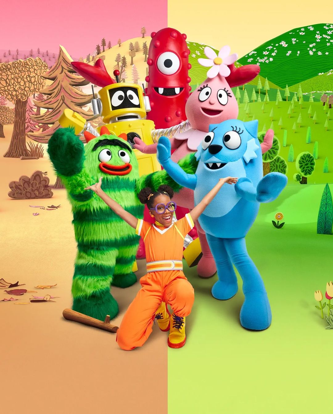 Human dressed in orange with Yo Gabba Gabba characters: Brobee, Foofa, Muno, and Toodee on a split tan and green cartoon landscape.