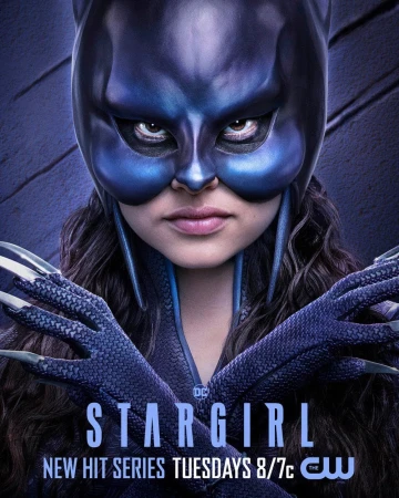 Promotional poster featuring a close-up of a person in a blue superhero mask and suit for the TV series Stargirl, a new hit series.