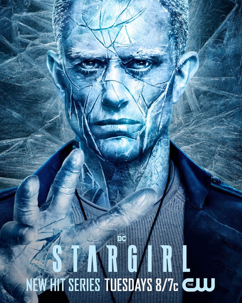 Close-up promotional image of a man with ice-like skin for the TV series Stargirl, with blue hues and icy background.