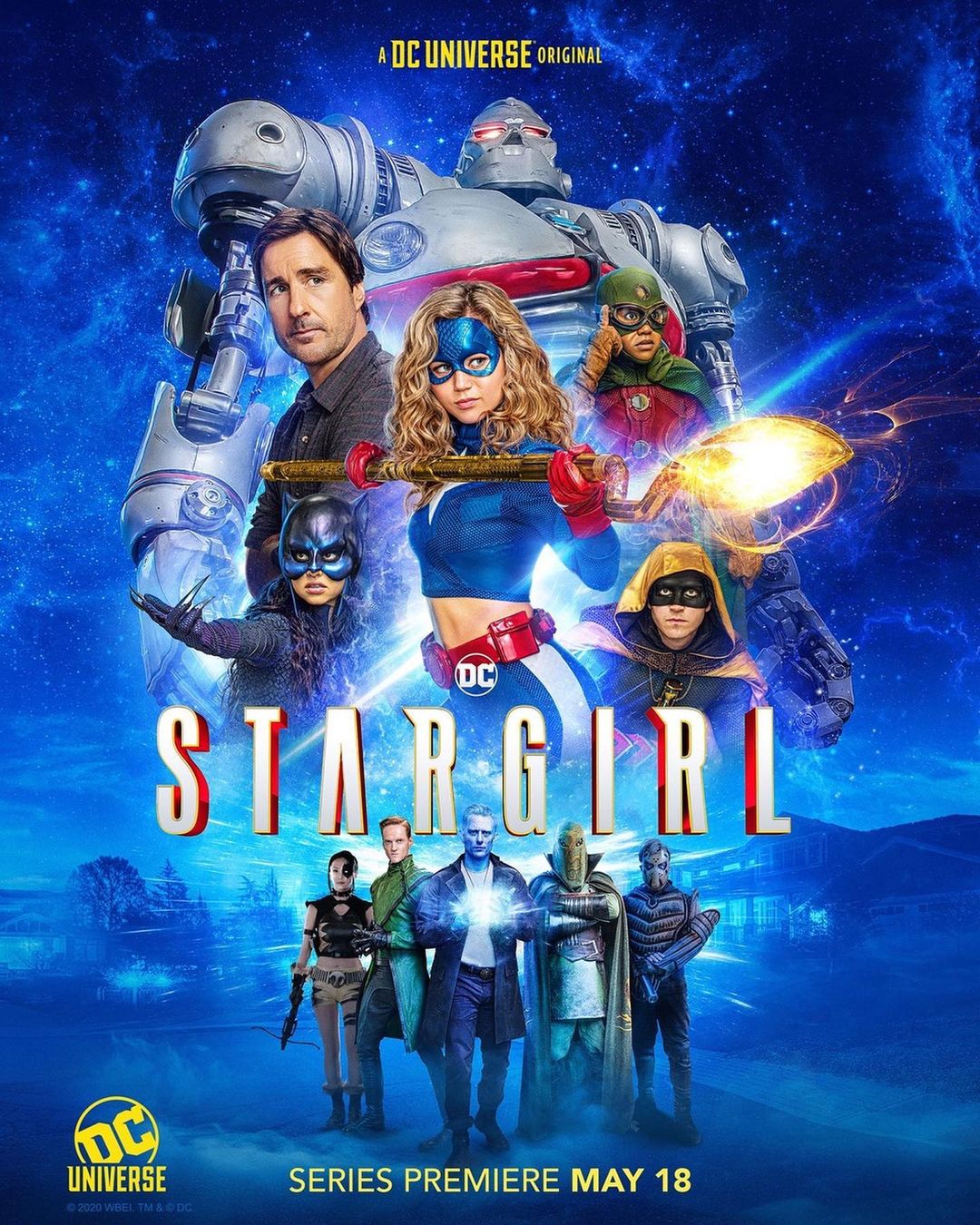 Promotional poster for Stargirl featuring the heroine surrounded by a team of heroes and villains set against a blue cosmic background.