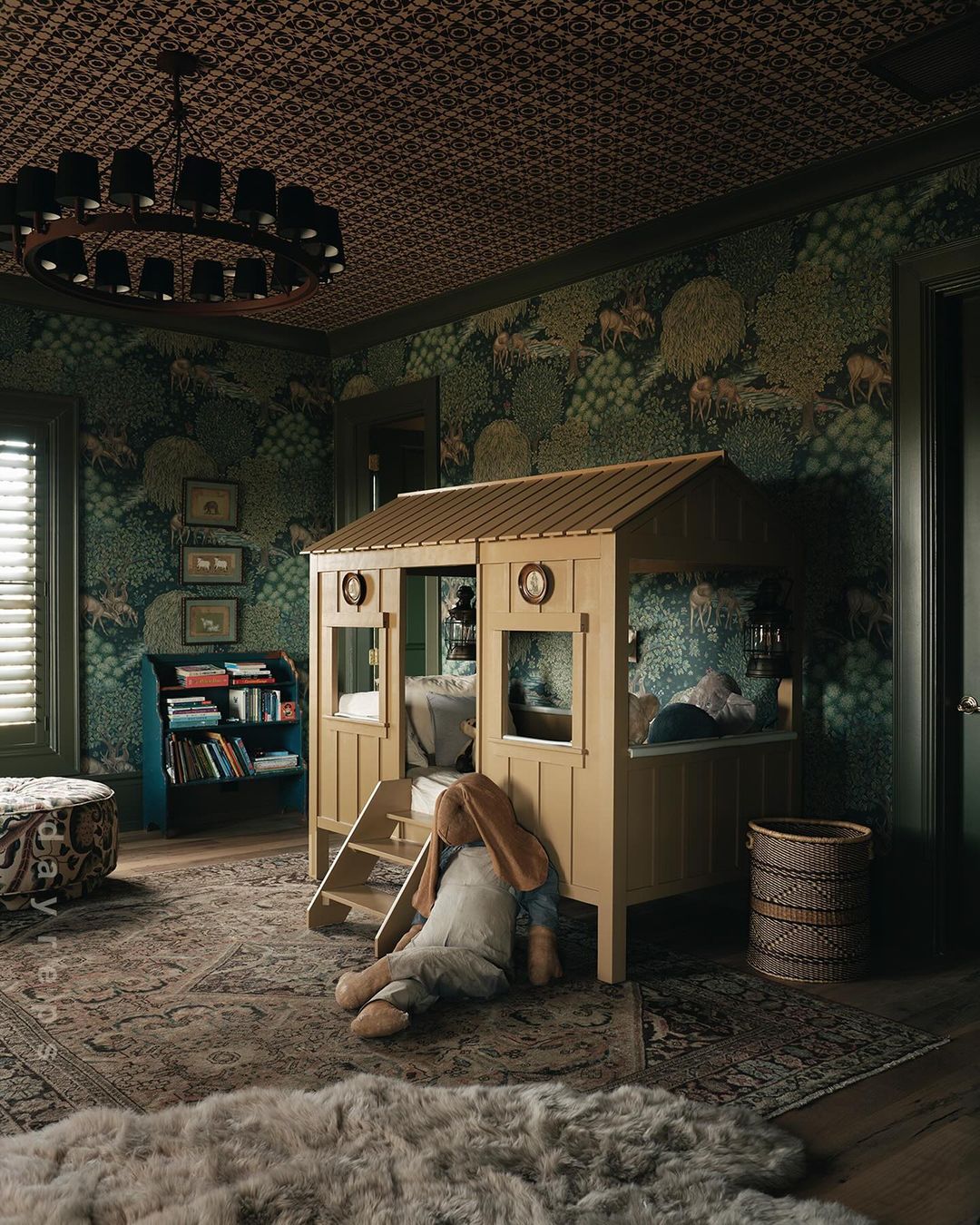 Cozy child's bedroom interior with a wooden playhouse bed, patterned wallpaper, ornate rug, and a large stuffed rabbit toy.