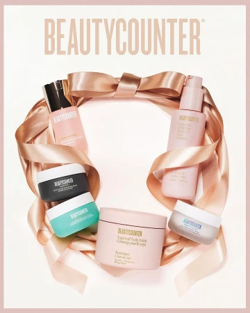 Beautycounter product display with skincare bottles, creams, and a peach satin ribbon on a white background in a promotional image.