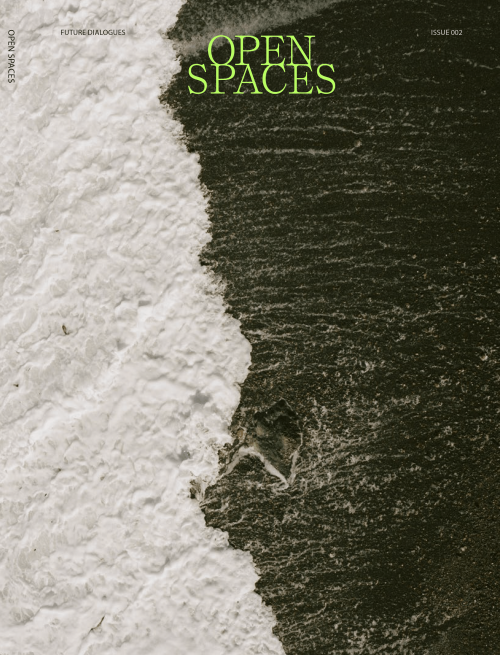 Magazine cover featuring ocean waves crashing on a dark shore with the title 'Open Spaces' in green text.