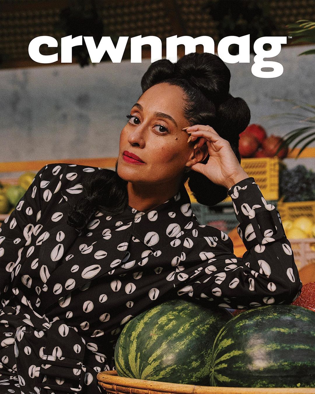 Fashion magazine cover featuring a stylish woman in a patterned dress, posing with watermelons and various fruits in the background.