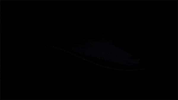Abstract black smear or brushstroke on a dark background. Monochromatic image with smooth texture and subtle lighting.