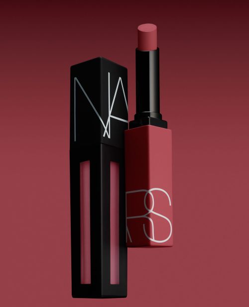 Two NARS brand lipsticks, one matte liquid lipstick in black packaging and one lipstick with a red tube, against a red background.