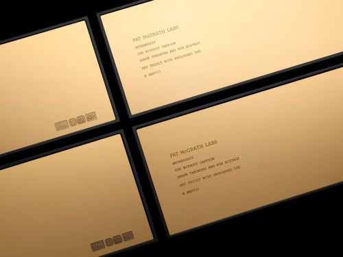 Four elegant gold cosmetic product packages with black borders, displaying the brand name Pat McGrath Labs and usage instructions.
