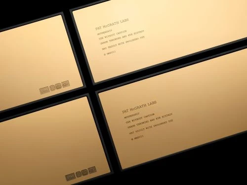 Four elegant gold cosmetic product packages with black borders, displaying the brand name Pat McGrath Labs and usage instructions.