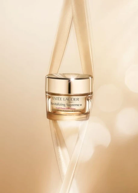 Estee Lauder Revitalizing Supreme+ Youth Power Soft Creme jar shot in a studio setting with soft lighting and a beige color palette.