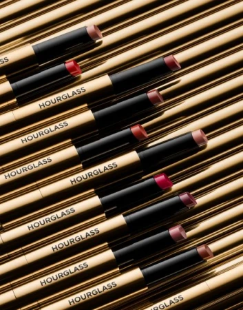 Hourglass Phantom Volumizing Glossy Balms arranged on a gold surface, showcasing makeup, beauty products, and cosmetic photography.