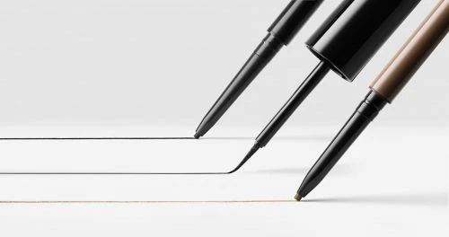 Cosmetic eyeliner and eyebrow pencils in black and brown on a white surface, demonstrating makeup application with drawn lines.