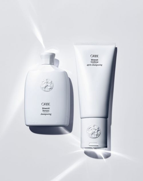 Oribe Silverati shampoo and conditioner bottles on a white background, product photography for beauty and personal care.