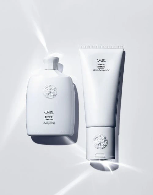 Oribe Silverati shampoo and conditioner bottles on a white background, product photography for beauty and personal care.