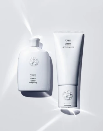 Oribe Silverati shampoo and conditioner bottles on a white background, product photography for beauty and personal care.