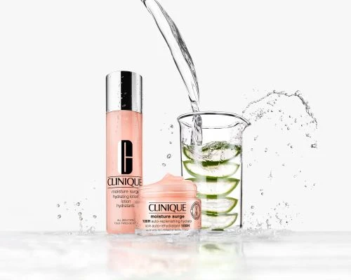 Clinique skincare product presentation featuring moisture surge lotion, cream, and a beaker of aloe slices with water being poured in.