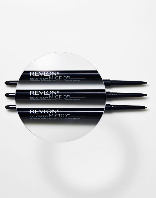 Three Revlon Colorstay Micro gel eyeliners displayed on a white surface with a magnifying glass over the center eyeliner.