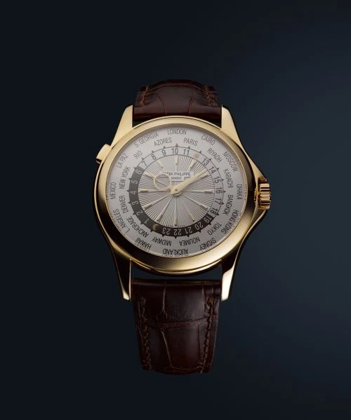Close-up of a luxurious gold wristwatch with a brown leather band, displaying a complex dial with multiple time zones.