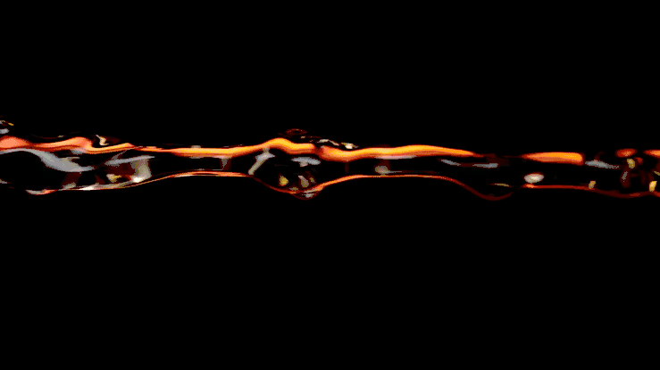 Amber-colored liquid stream in motion against a stark black background, showcasing fluid dynamics and vibrant color contrast.