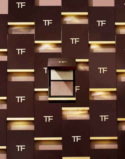 Tom Ford eyeshadow palette with gold lettering on brown packaging, and matching product display background