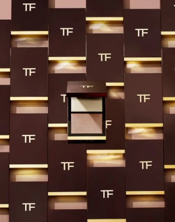 Tom Ford eyeshadow palette with gold lettering on brown packaging, and matching product display background