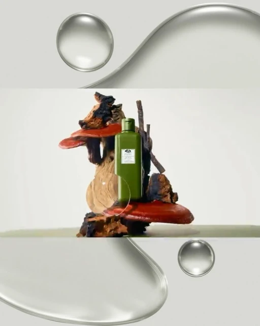 Green skincare bottle sits on a wood sculpture, set against a bright background with clear water droplet-like orbs in the composition.
