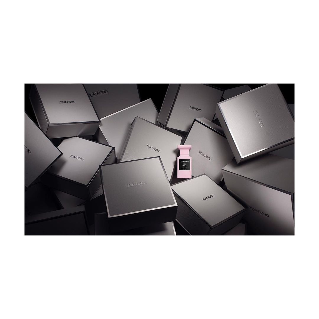 Tom Ford perfume bottle surrounded by Tom Ford product boxes creating a luxurious, high-end beauty product presentation.