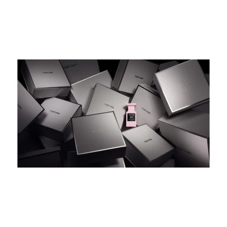 Tom Ford perfume bottle surrounded by Tom Ford product boxes creating a luxurious, high-end beauty product presentation.