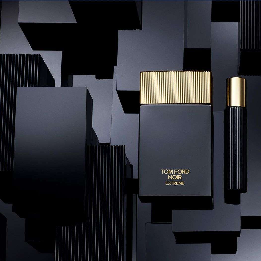 Tom Ford Noir Extreme fragrance bottles stand against a geometric black block background, showcasing modern beauty and design.