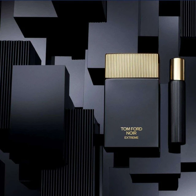 Tom Ford Noir Extreme fragrance bottles stand against a geometric black block background, showcasing modern beauty and design.