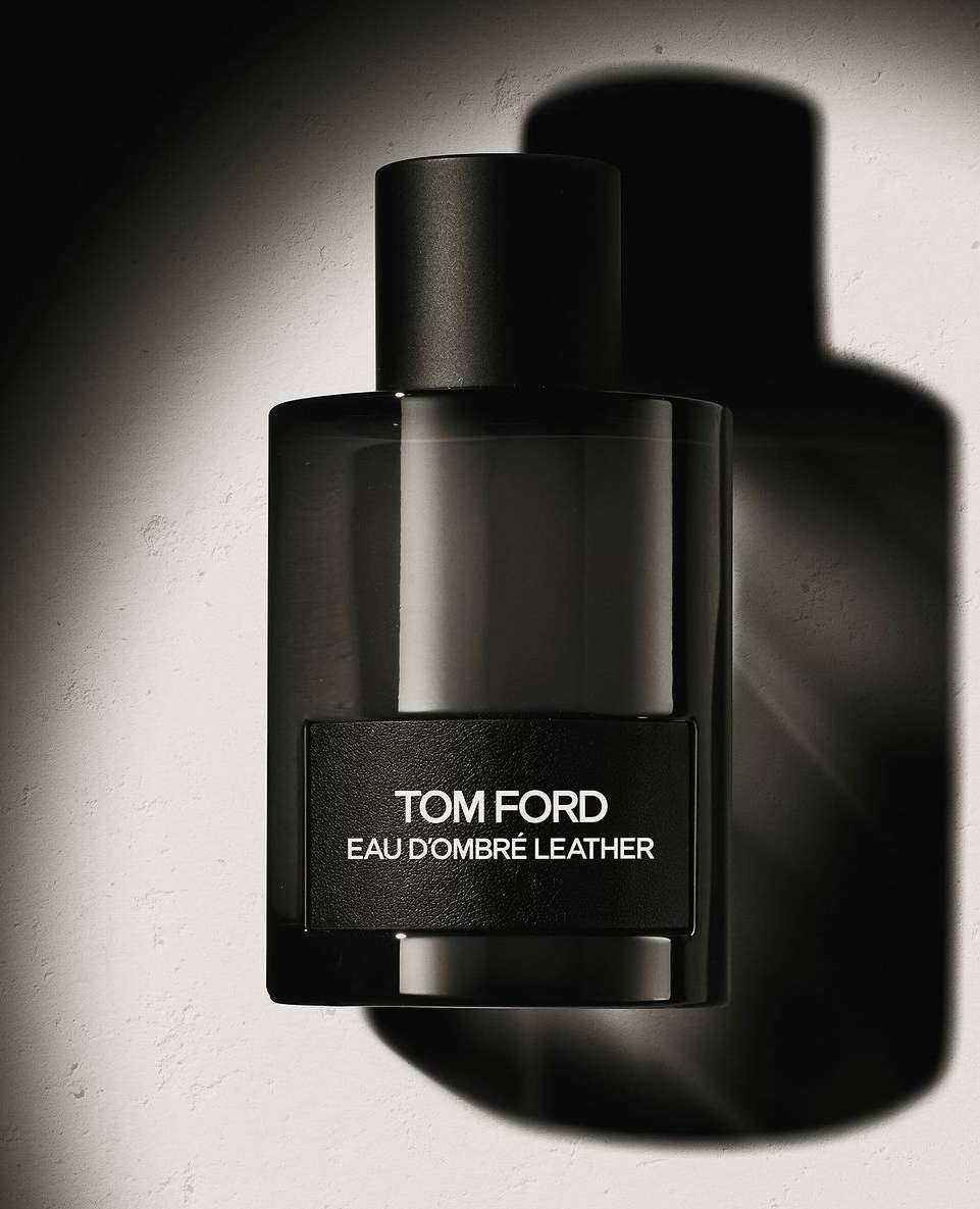 Studio shot of Tom Ford Eau d'Ombré Leather fragrance in a rectangular glass bottle with a black label and cap, set against a neutral backdrop.