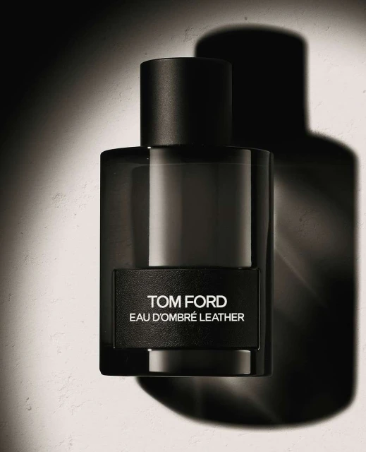 Studio shot of Tom Ford Eau d'Ombré Leather fragrance in a rectangular glass bottle with a black label and cap, set against a neutral backdrop.