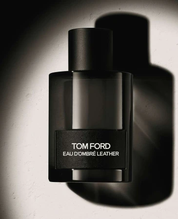 Studio shot of Tom Ford Eau d'Ombré Leather fragrance in a rectangular glass bottle with a black label and cap, set against a neutral backdrop.
