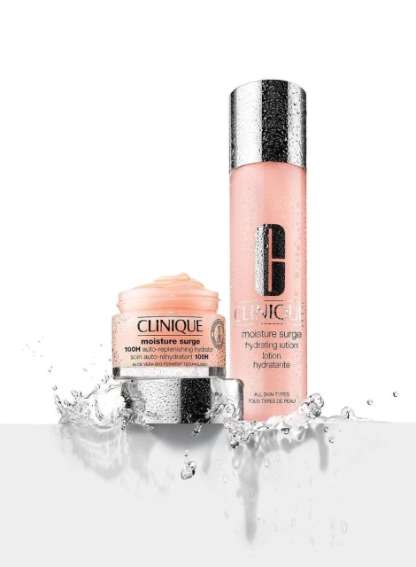 Clinique skincare products on a white surface with water splashes: moisturizer and lotion, showcasing clean beauty and hydration.