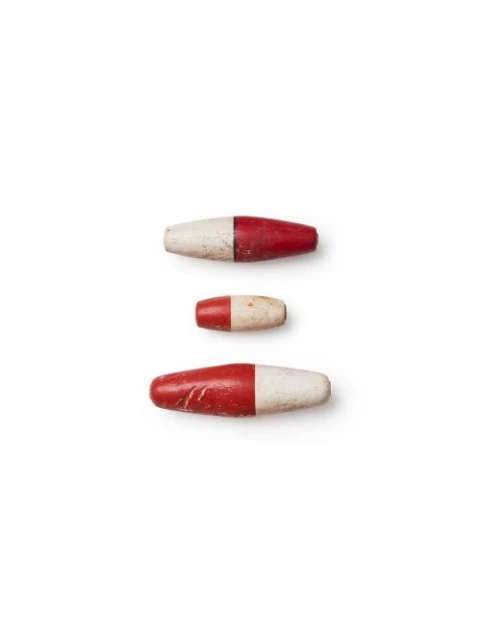 Three rounded, oblong objects are presented in a vertical arrangement on a stark white backdrop, each featuring a dual-color scheme of red and white.