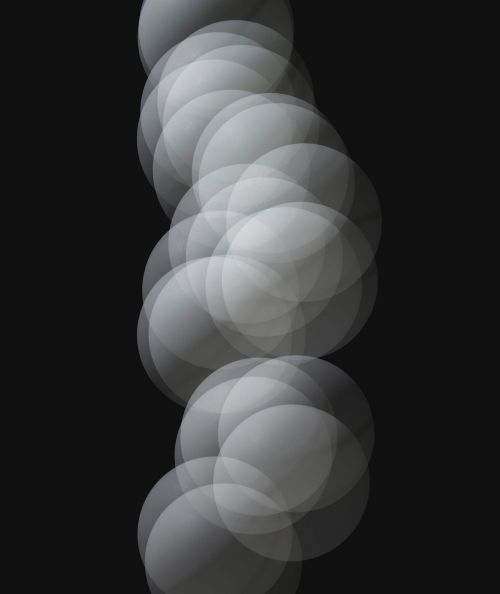 Abstract image with a series of overlapping translucent gray circles, creating a soft, textured, and ethereal visual effect against a dark background.