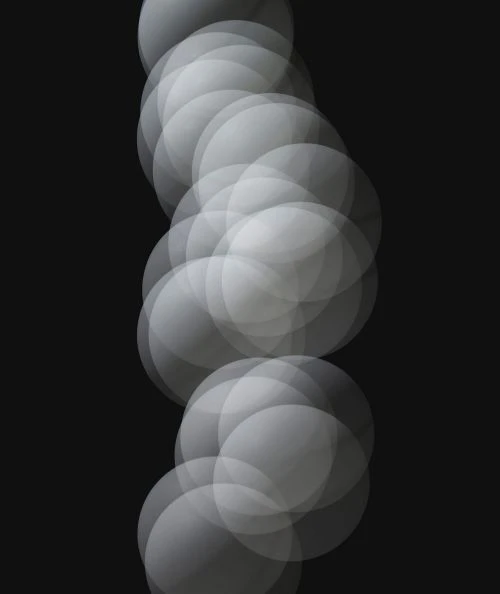 Abstract image with a series of overlapping translucent gray circles, creating a soft, textured, and ethereal visual effect against a dark background.
