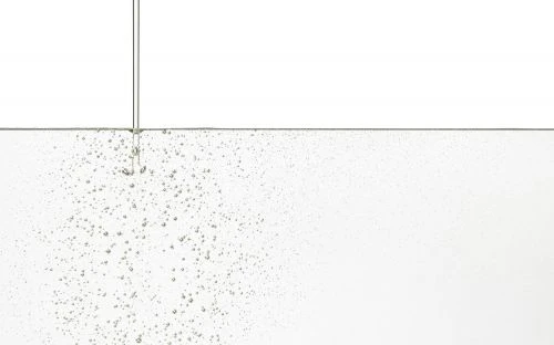 Effervescent water filling the frame, featuring tiny bubbles against a white background, clear and clean, perfect for visual backgrounds.