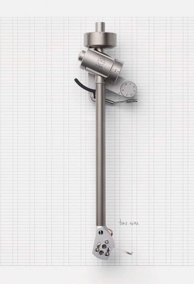 Close-up of a silver turntable tonearm against a white grid background. Studio shot emphasizes the tonearm's design and precision.