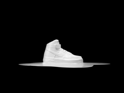 High-top athletic shoe in white on a white surface, isolated against a black background in a studio product shot for footwear.