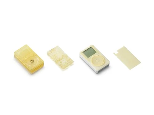 Arrangement of disassembled iPod models on a white background, showcasing the device components and design, suitable for technology or design content.