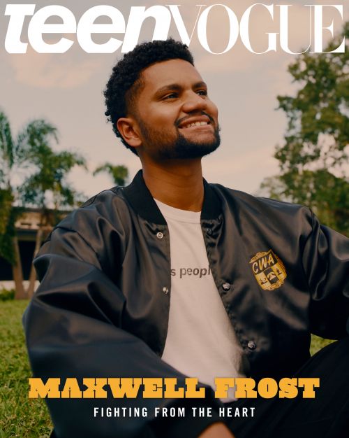 Teen Vogue magazine cover featuring Maxwell Frost smiling, wearing a jacket and t-shirt, and sitting on grass near a building and trees.