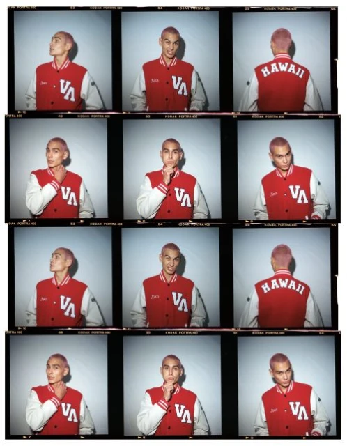 Contact sheet featuring a young adult male model with short, pink hair wearing a letterman jacket in a photo studio against a grey backdrop.