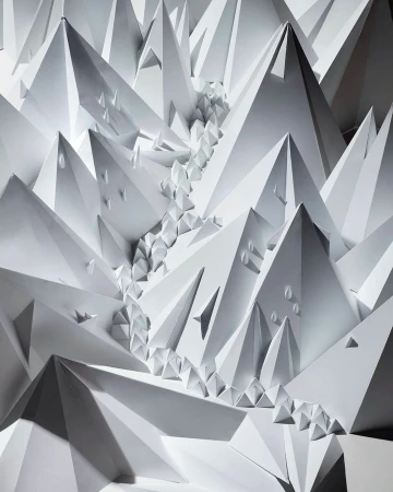 Paper art design featuring abstract geometric mountain peaks and river, creating a monochromatic landscape with shadows and depth.