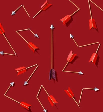 Conceptual image of multiple arrows on a red background, with one arrow aligned vertically and the others pointing in different directions.