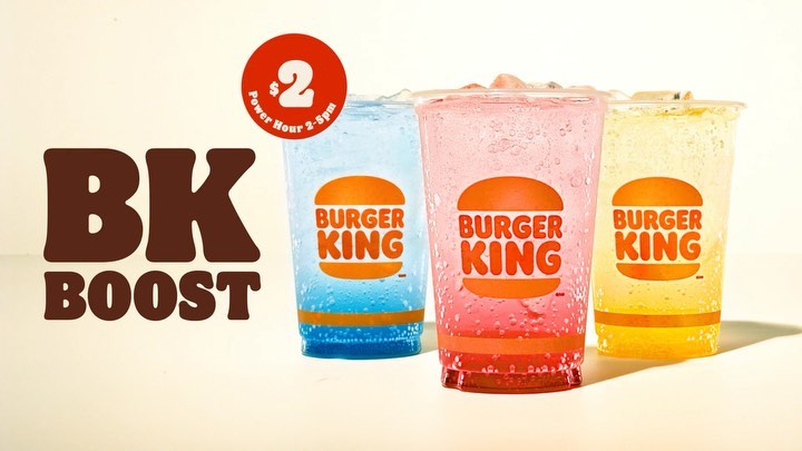 Burger King beverage promotion with three colorful soda drinks in plastic cups displayed next to a BK Boost advertisement.